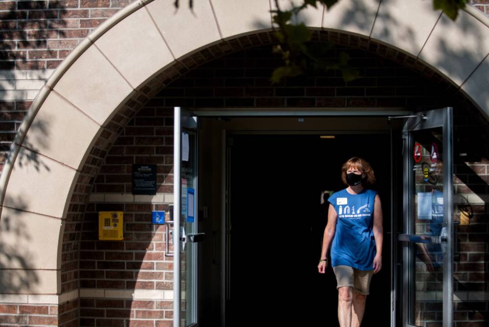 Alumna walking out of building